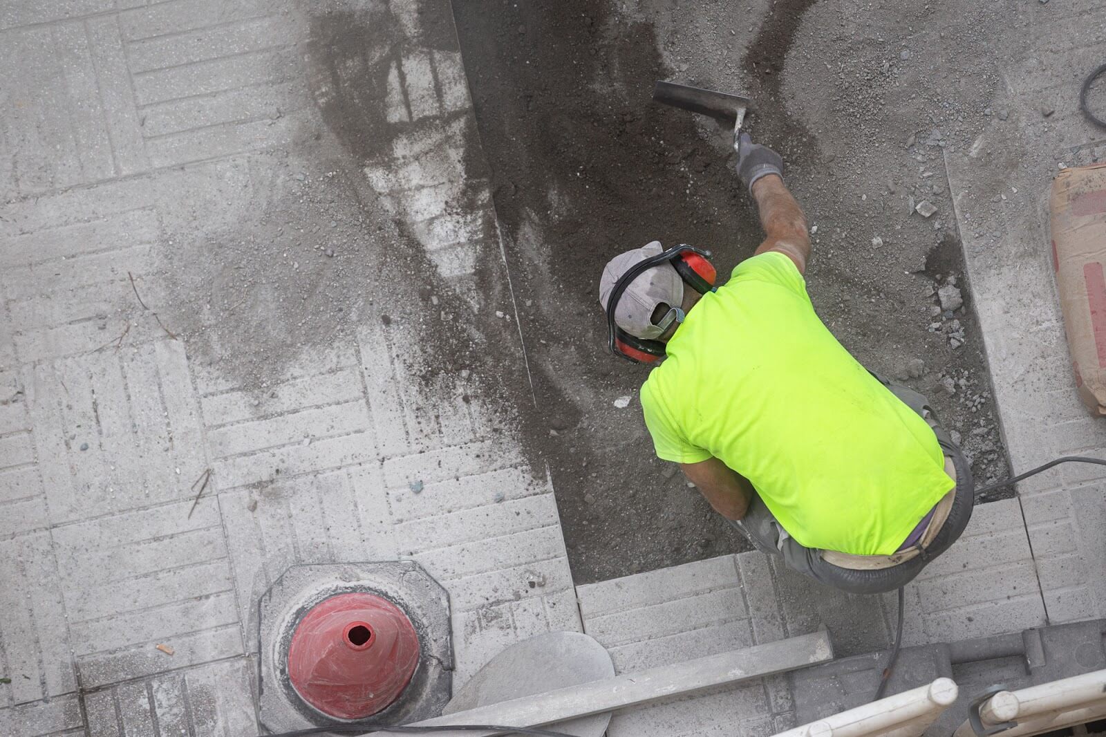 Construction worker repairing a sidewalk. Maintenance concept